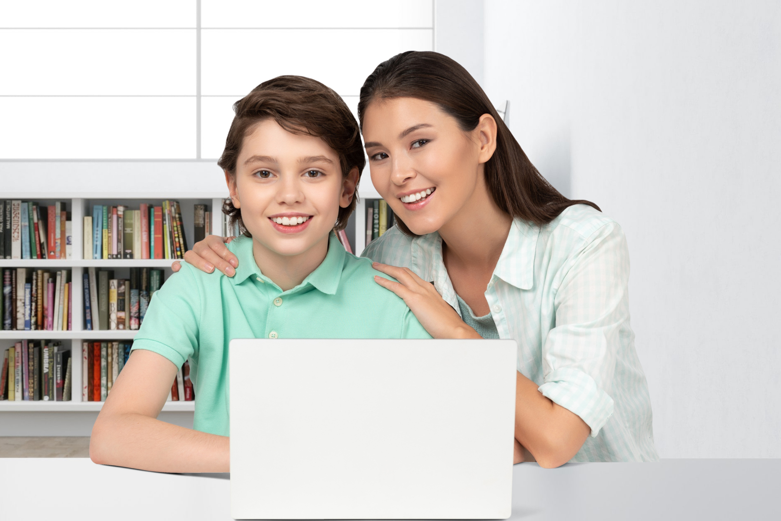 Why Photography and Videography Matter for Your Website: mom and son sitting at a table with a laptop