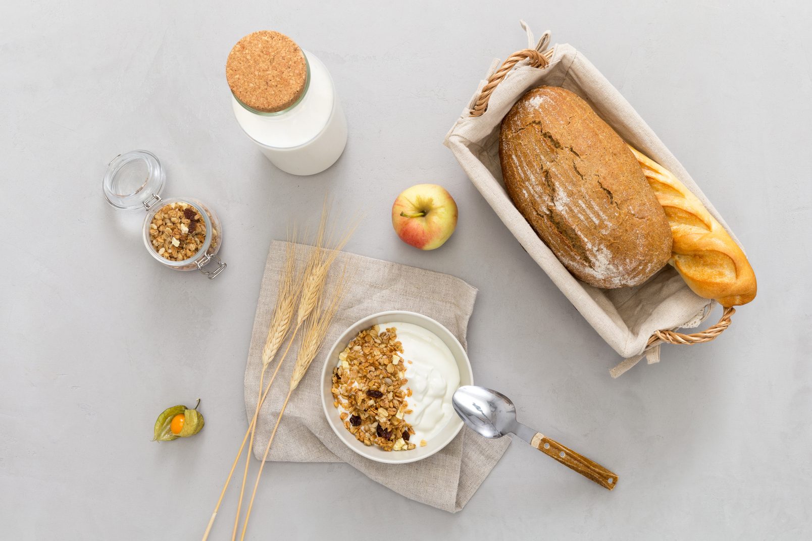 World milk day 2021: top view: there is a plate of muesli, a bottle of milk, rye bread on the table.